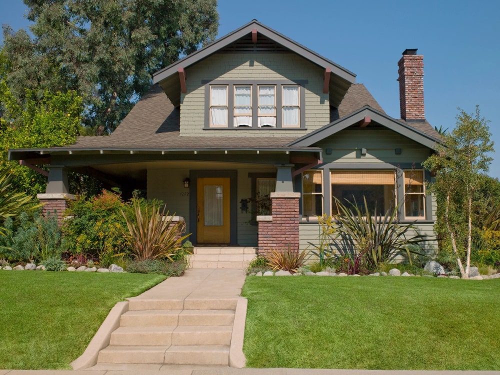 A house with grass and bushes around it